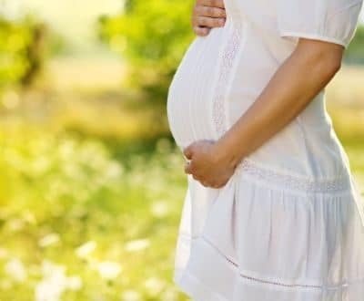 Pregnant Lady holding her Baby bump. Non-Invasive prenatal paternity test to determine Paternity of unborn child